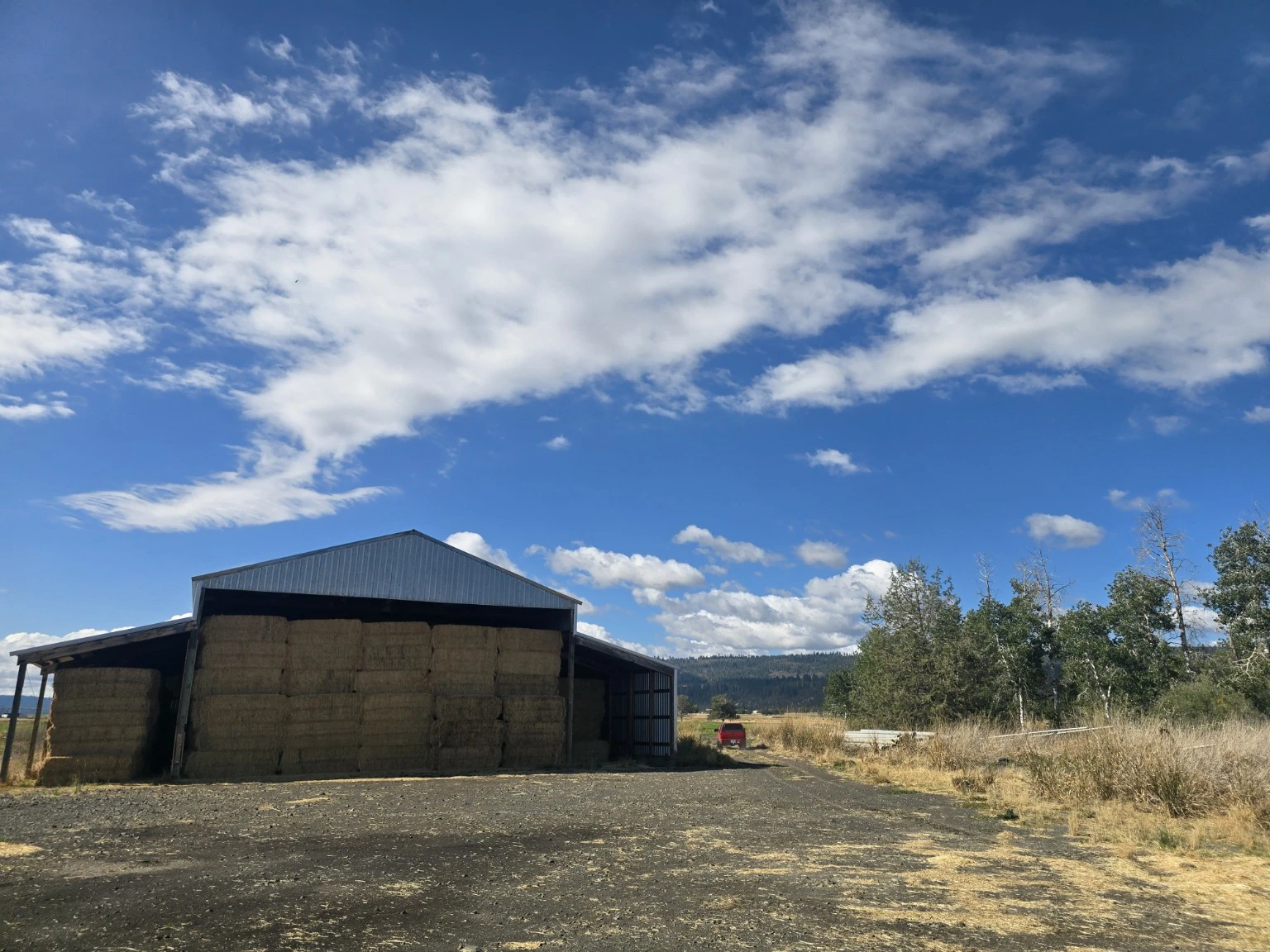 Ranch hay barn shown in its surrounding landscape