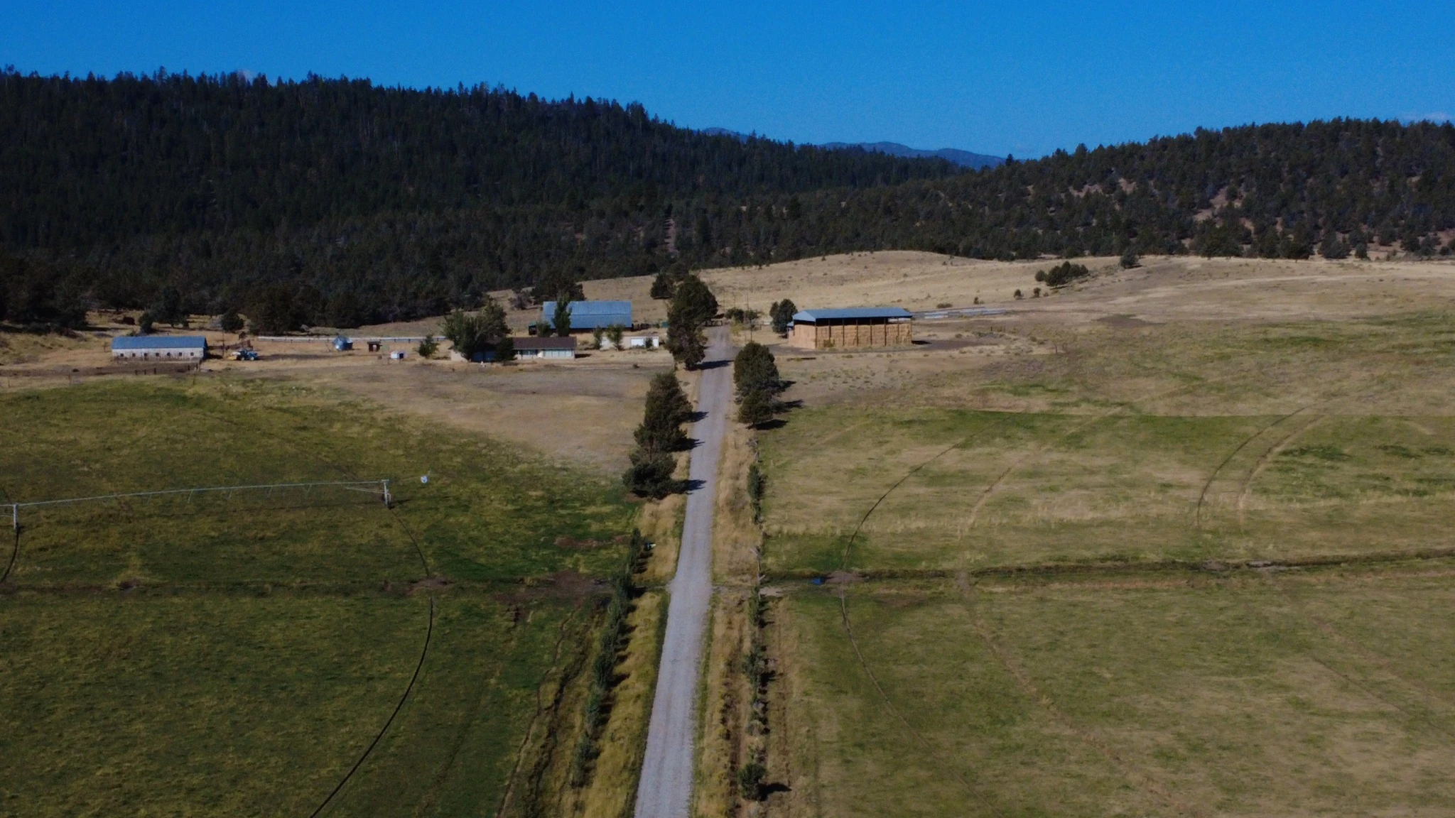 Aerial view along Andy Hill Road toward the ranch headquarters and fields